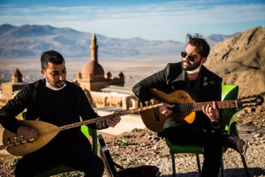 Two Men With Guitars In Turkey
